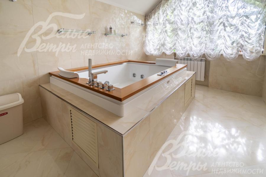 Комфортная большая ванна с подголовниками и отделкой бортиков под дерево