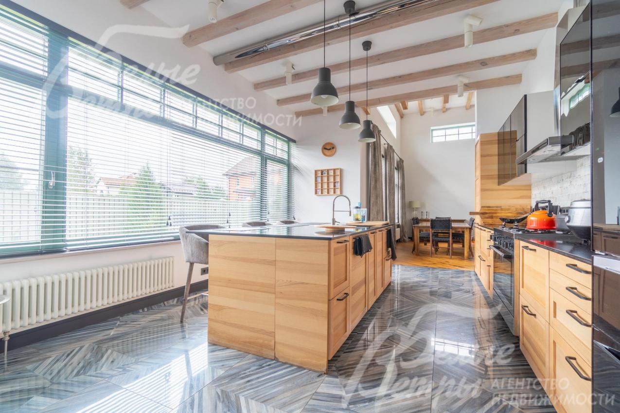 Кухня с большим окном и гарнитуром из массива дерева