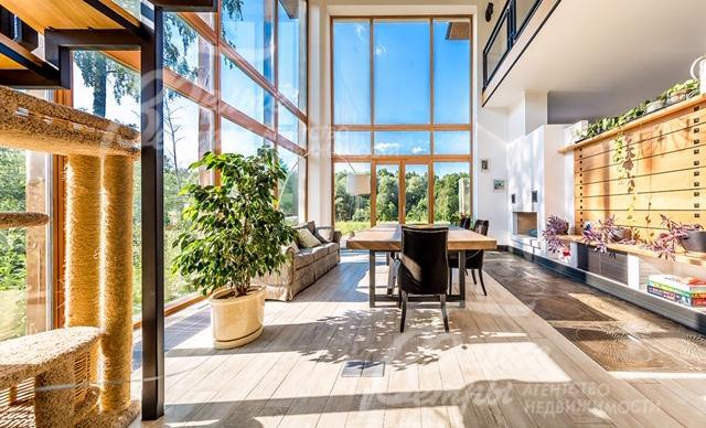 Двусветная гостиная с камином и панорамным остеклением